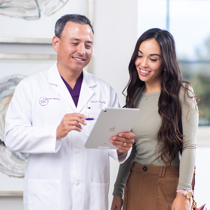Doctor showing patient information on a tablet.