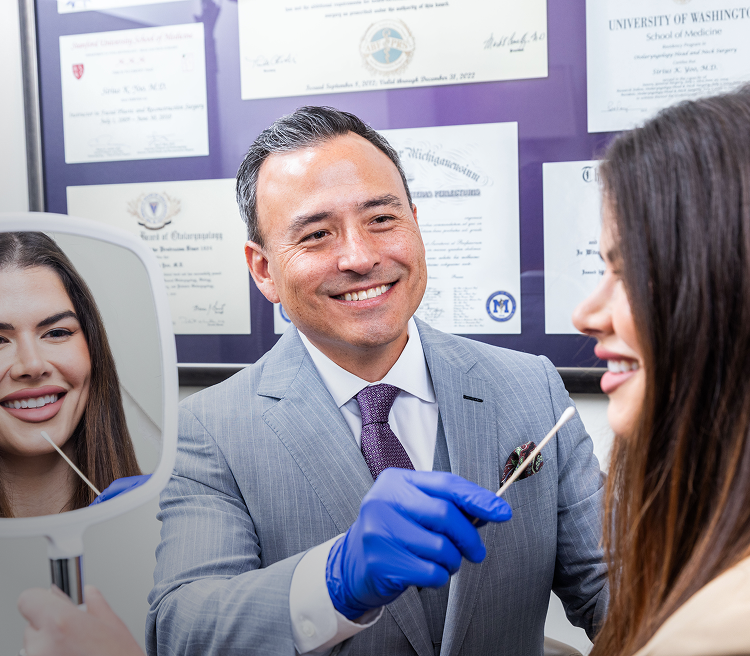 Dentist discussing treatment with smiling patient.